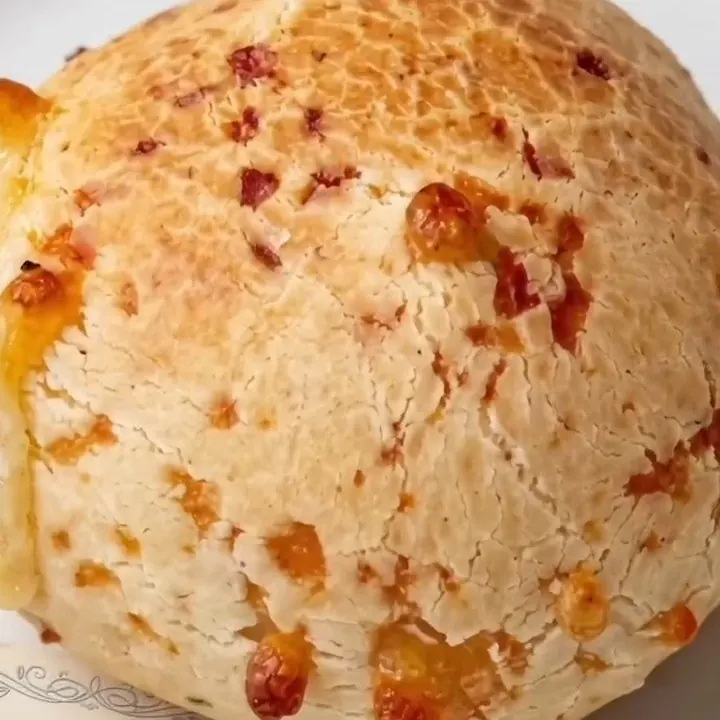 Primer plano de un chipá dorado con queso